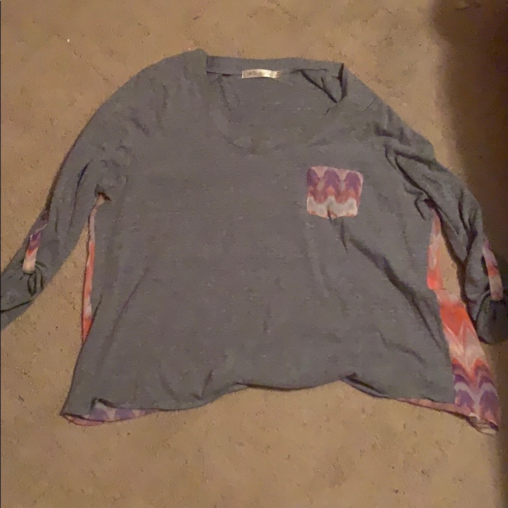 A grey dress shirt with a colorful back
